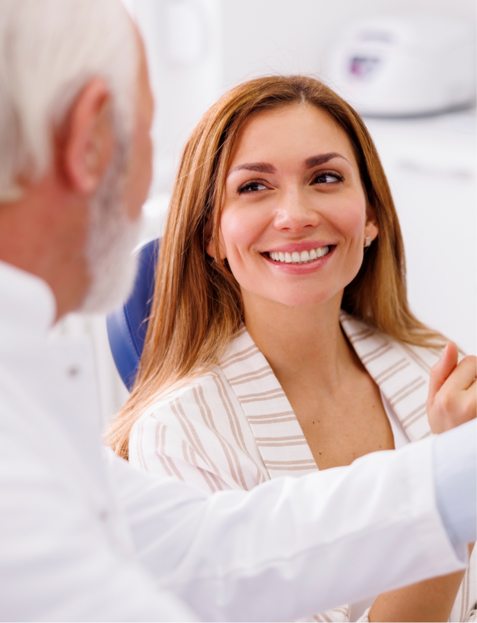 happy customer smiling with a dentist at the dental clinic and implantology clinic