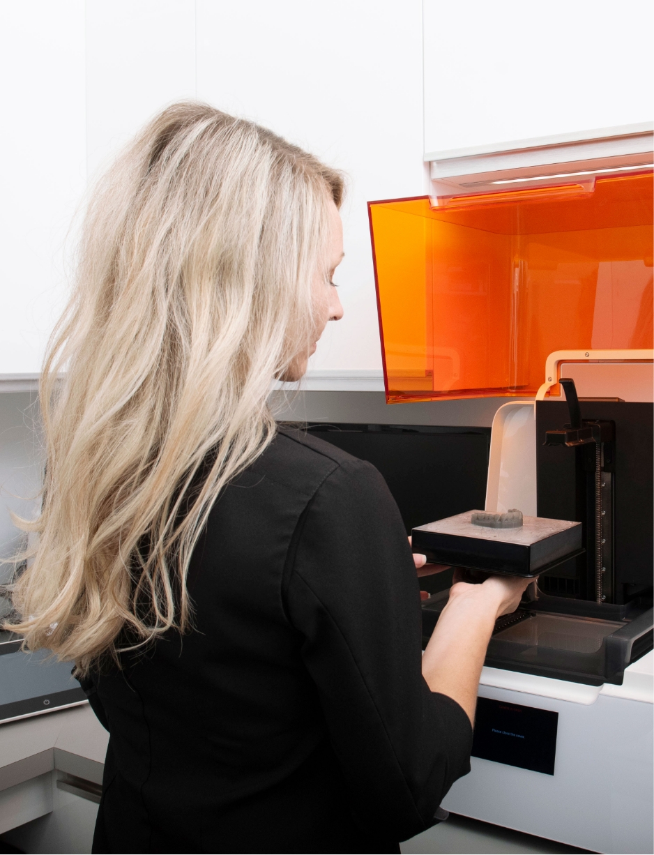 an image of a female dentist using CEREC technology