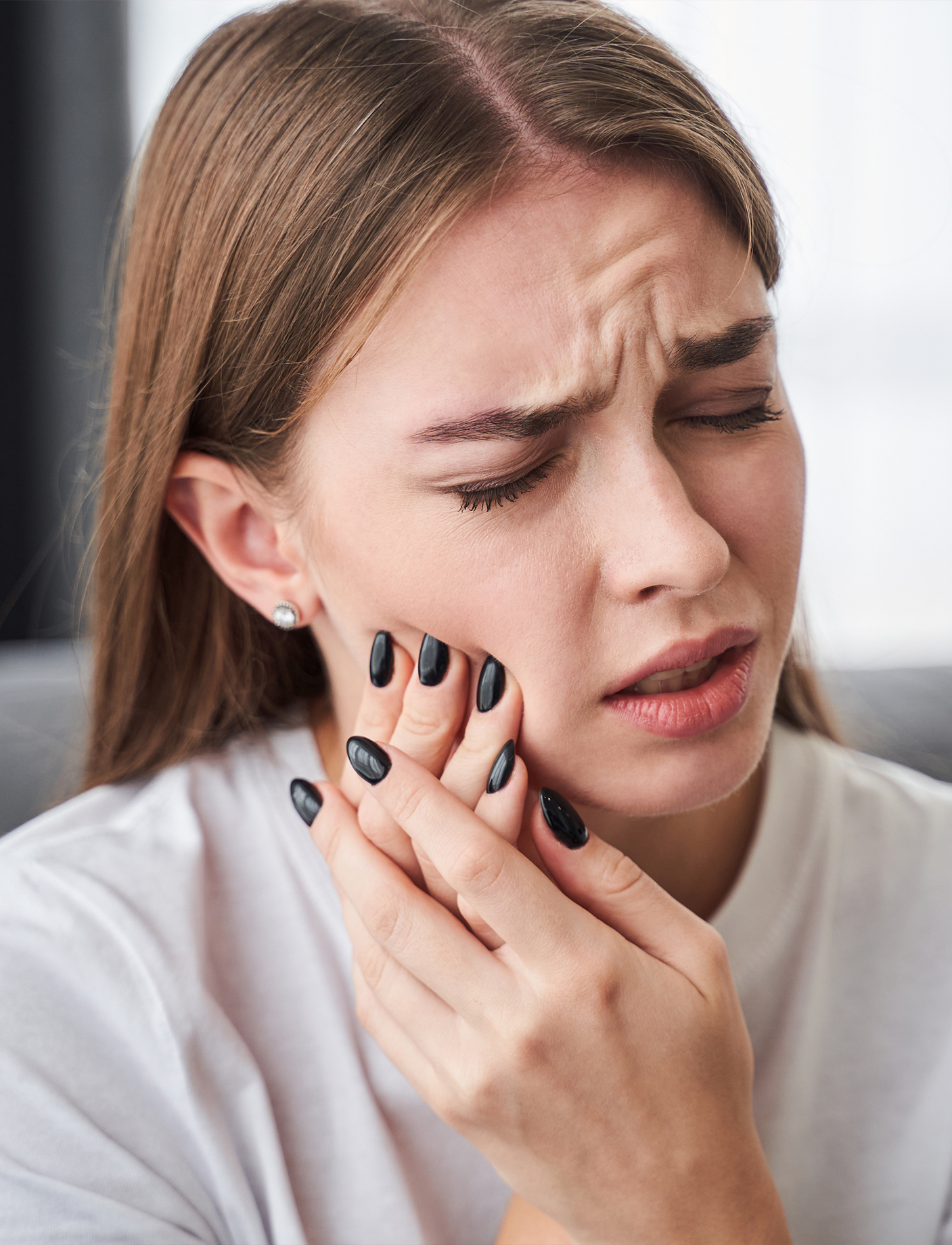 an image of a lady experiencing dental pain because TMJ disorder