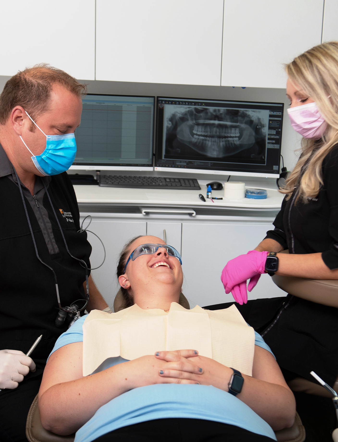 Dentist Alain Cyr and a hygienist treating a woman for a dental cavity
