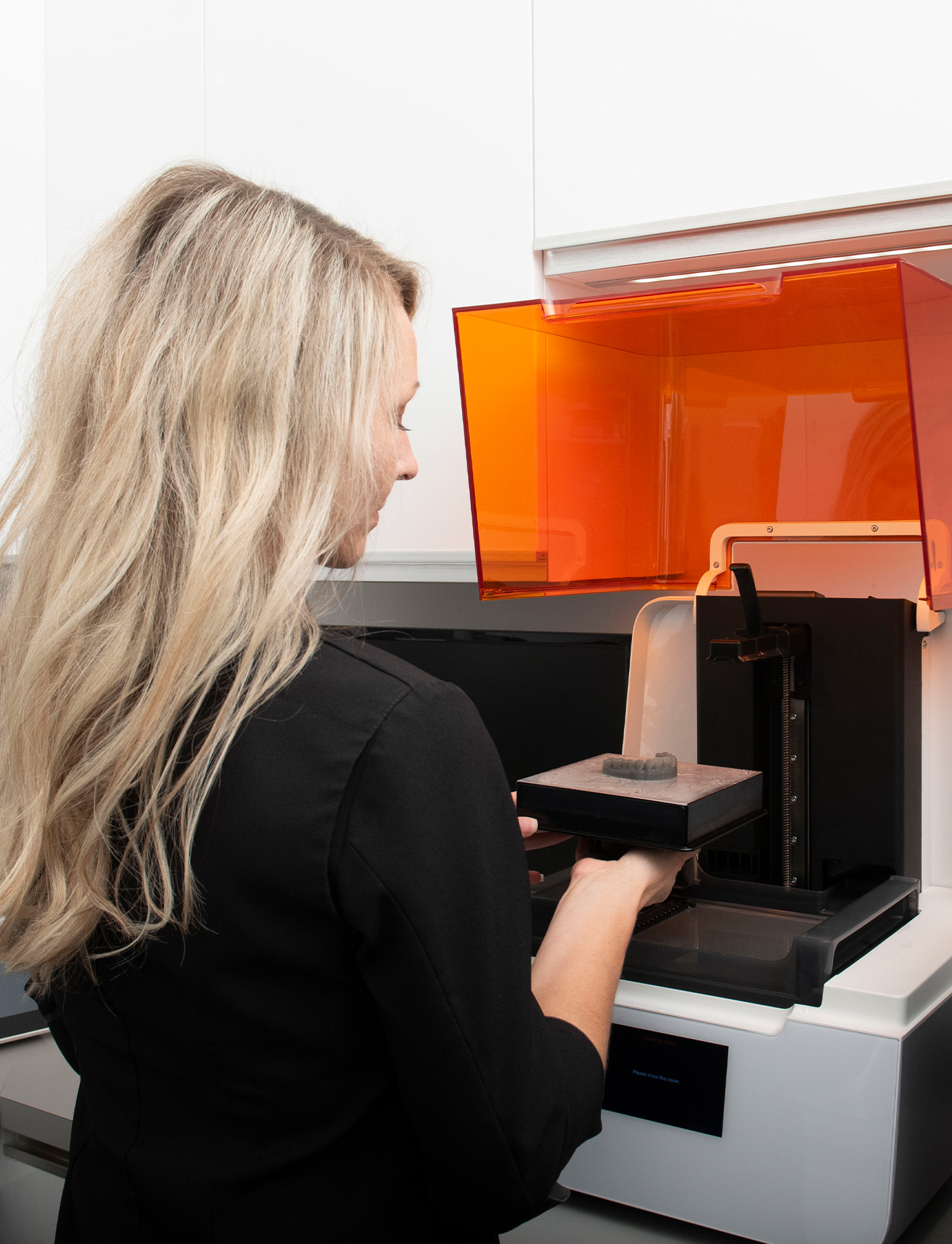 a dentist specialist getting a 3D print of a dental implant