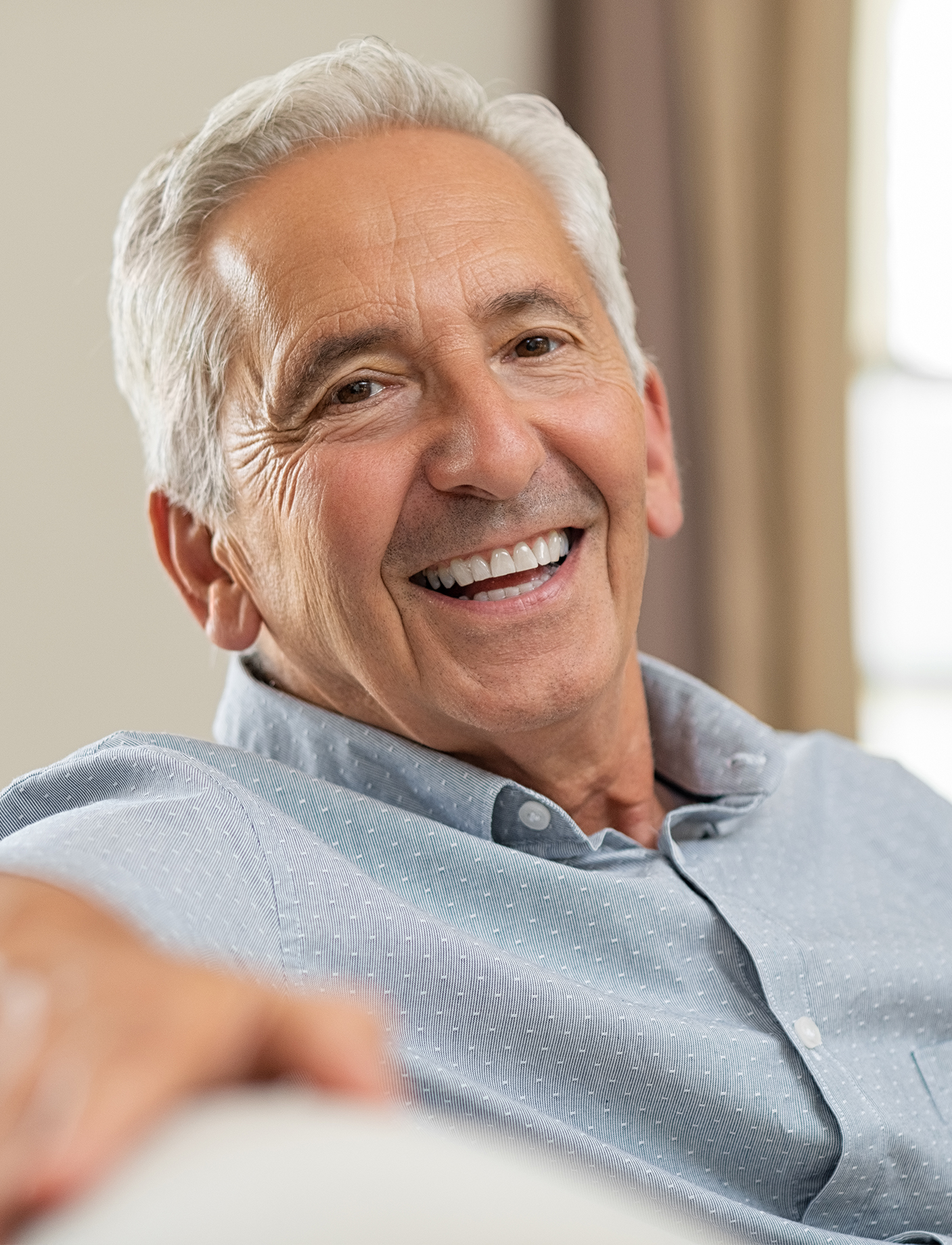 a picture of an elderly man smiling with a beautiful smile made of prosthetic teeth